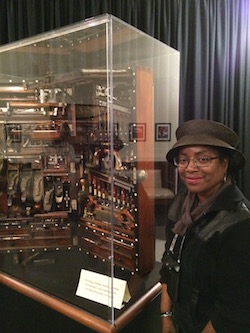 Shirley J standing beside the Studley chest