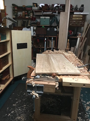 wood shavings and glued up panel on the wood bench 