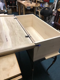 Fitting hinges to attache the lid to the chest.
