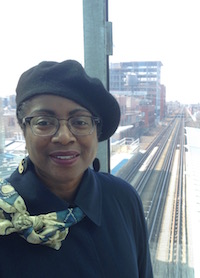 Shirley J standing on elevated train platform 