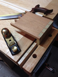 Finished dovetail block with saw and block plane