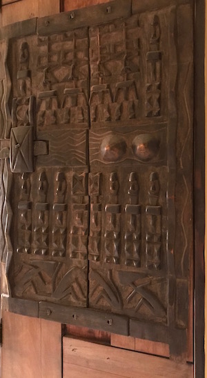 Carved Dogon door of the Mali people in Africa representing Kwanzaa principle Kuumba