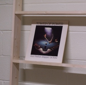 Testing height of shelf for adequate hand grab space for album
