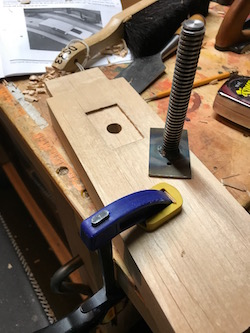 A mortise for the saw sharpening vise acme screw.