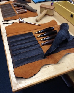 Chisels in leather tool roll for protection.