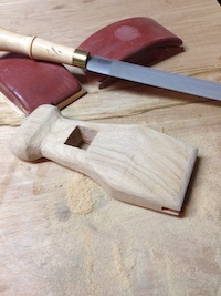 Sanded hand held hammer head with sanding blocks and rasp.