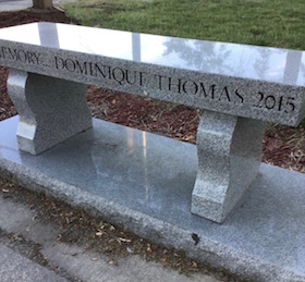 Granite bench dedicated to Dominique Thomas in front of the high school before her "walk" as a pilgrim on the camino.