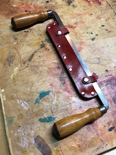 Drawknife in red dye stained leather sheath.
