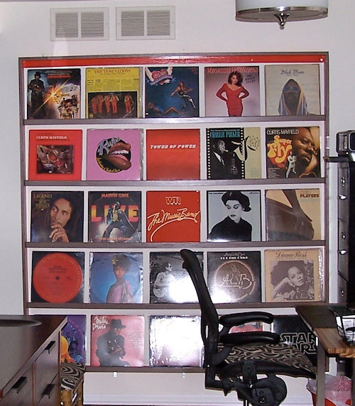 Closeup of the vinyl album rack mounted on the wall.