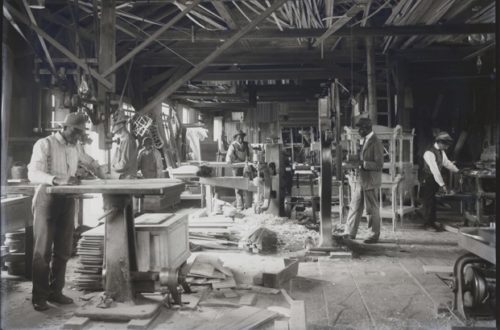 Black make students in a furniture making wood shop.