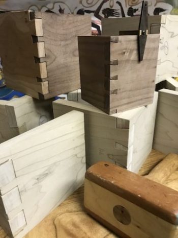 Stacked dovetails blocks with wooden mallet and dovetail marker