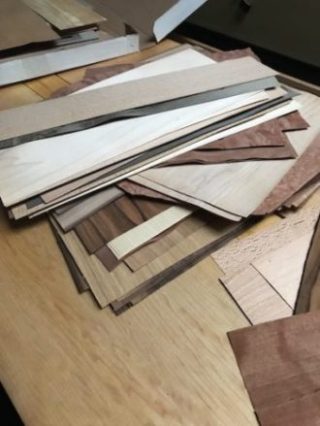 A collection of wood veneer on the wood bench.
