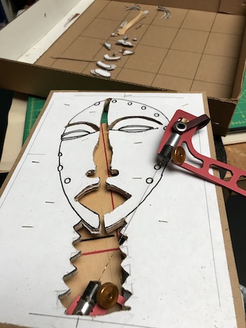 The Mask marquetry packet being cut out on the fret saw table.