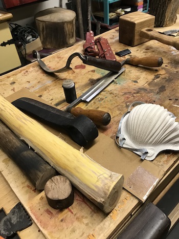 Froe head and tools used to shape wooden handle in bench vise