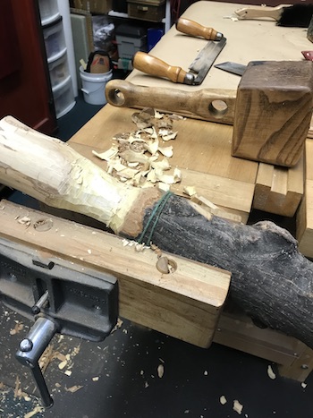 Shaping wooden mallet in bench vise