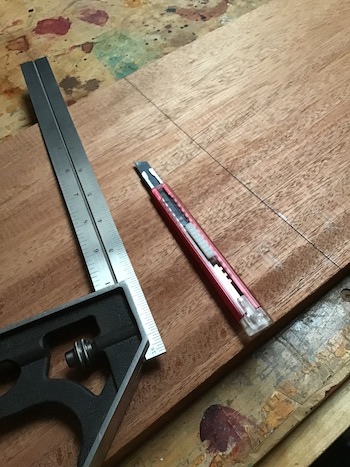 Tri square and marking knife for cutting the mahogany plank.