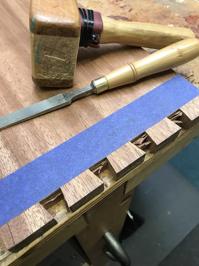 Cleaning up the waste after cutting the tails. Blue tape at scribe lines showing growth in learning better techniques. 
