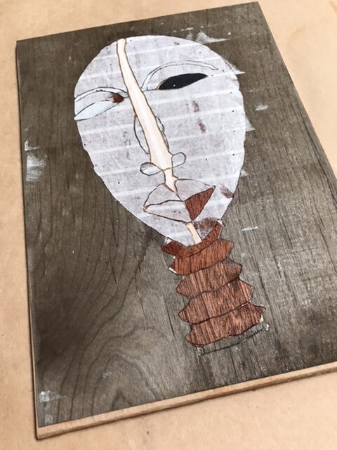 Removal of veneer tape from Dan mask marquetry image will leave the cartoon behind.