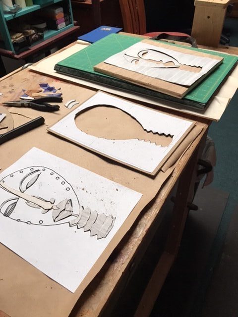 In-progress assembly of Dan mask marquetry image: cutout, layout and partial assembly.
