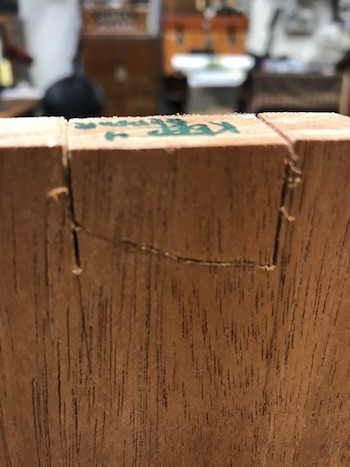 Pin block mistake caused by cutting beyond the scribe line with the fret saw.