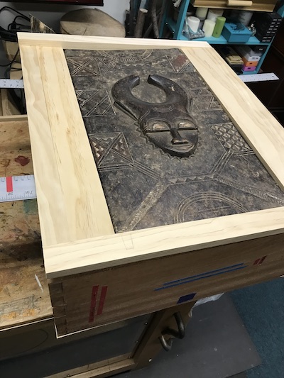 Baule door fitted into frame atop cabinet carcass.