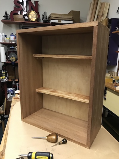 Cabinet with the dry fitted shallow shelves as a symbol of repurposing.