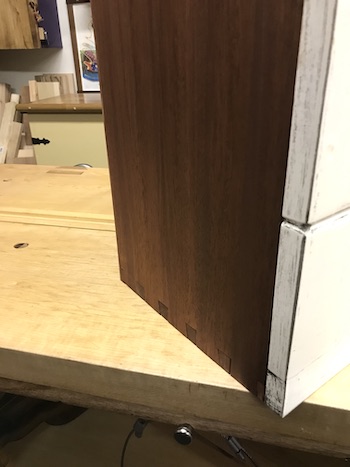 Closeup of dovetails on side of cabinet.