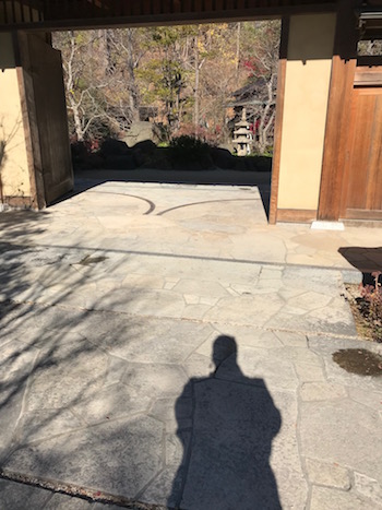 A shadow at the gate to the Japanese garden.
