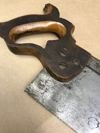 Old saw handle and blade in need of restoration.