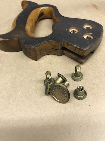 Old handle and saw nuts before restoration.