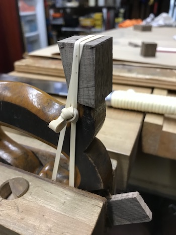 Horn repair with walnut block glued to horn tip.