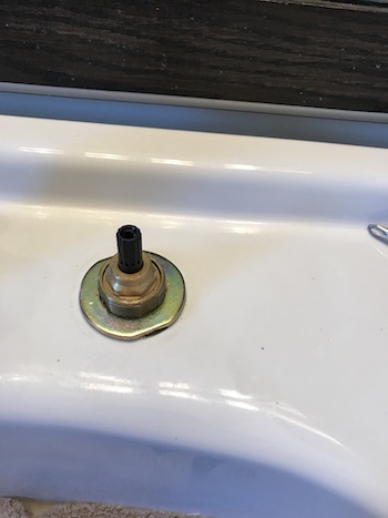 Faucet repair completed on clean sink.