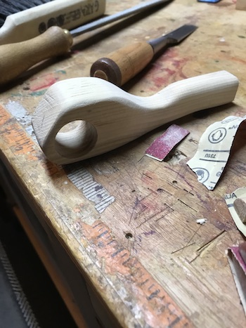 The shaped wood handle for the fret saw.