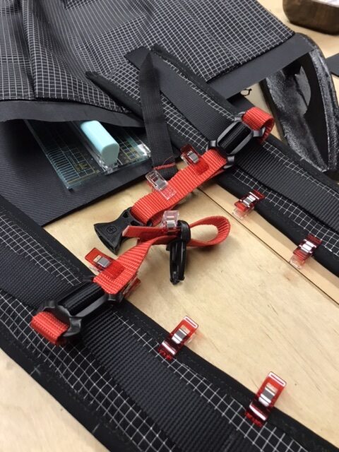 Orange sternum strap for shoulder straps.