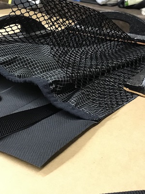 Mesh pocket being fitted on the large backpack pocket.
