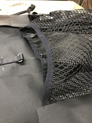 Attached dual fabric and mesh pockets at the front of the backpack.
