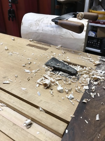 Log and drawknife on bowl blank..