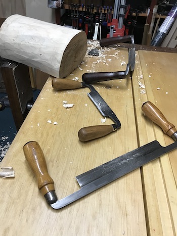 Drawknives used to clean log after removal of bark.