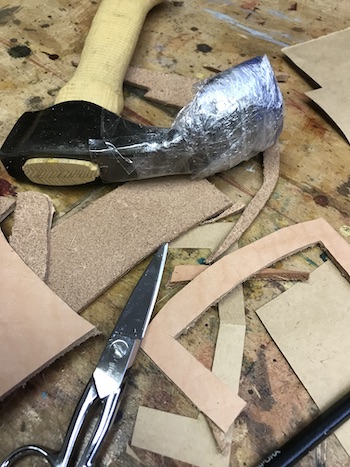 The adze head covered with plastic before wet forming.