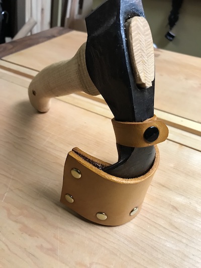 Adze "standing" on leather sheath.