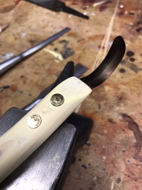 Front view of hook knife blade attached to new wood handle.