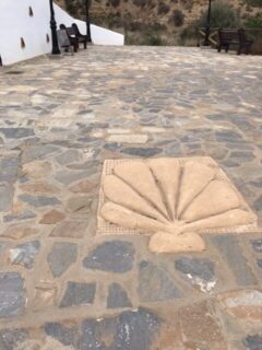 The carved stone shell on a village road.