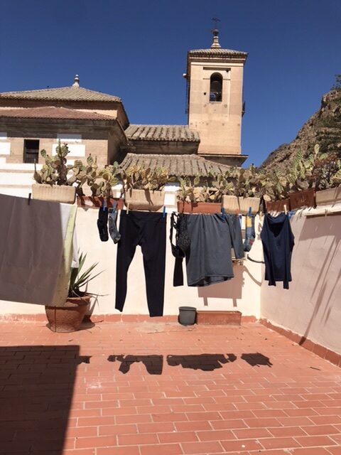 Laundered clothing hanging to dry in the albergue terrace on the camino Mozarabe.