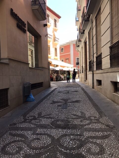 A Street in Granada paved with tiles in a Moorish design.