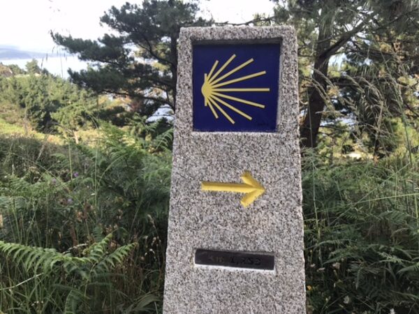 A camino marker on the road to the zero kilometer marker in Fisterra.