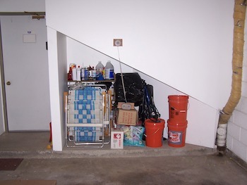 Garage storage space with stacked items.