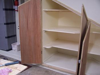 Open doors of the left side of garage storage space.