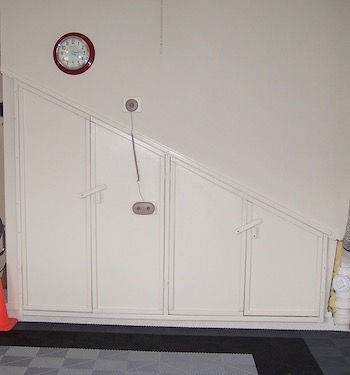 Perfect garage storage space with doors and a clock.