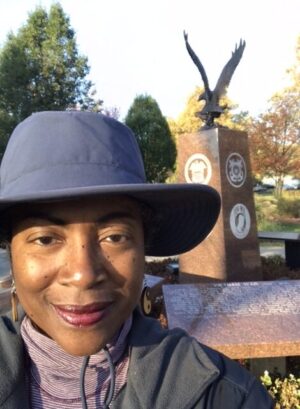 Pausing in front of a Memorial to American troops at a neighborhood park on a brisk fall day