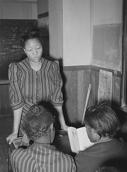 Black teacher and students determined to learn.